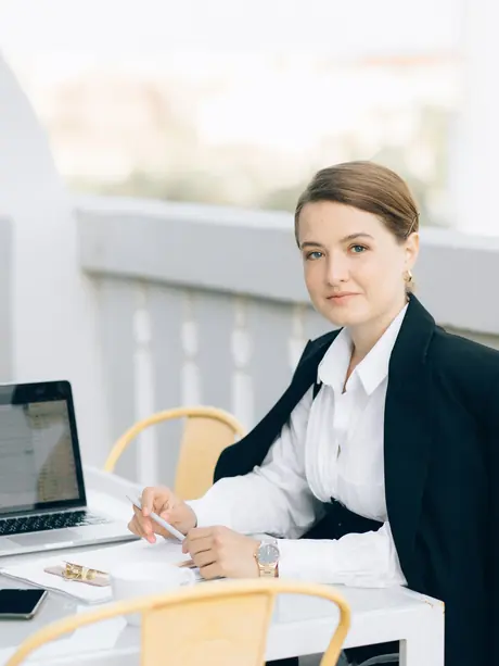 Adviser at a desk with a laptop, ready to answer mobile plan questions by phone